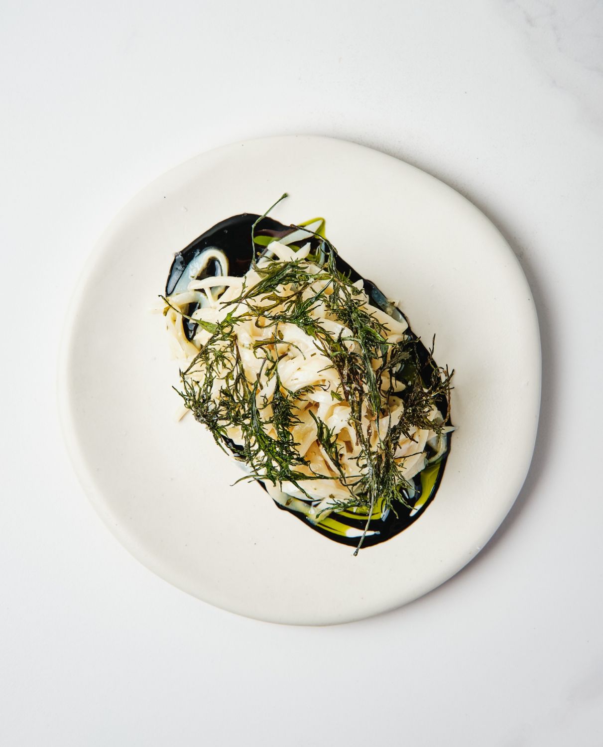 Butter poached squid with ink and kale | Ember by Josh Boutwood