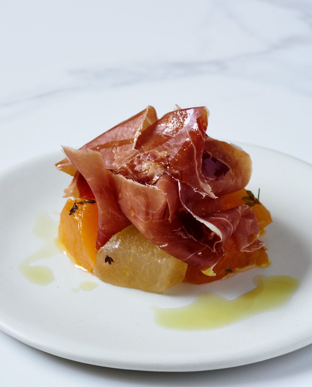 Melon compressed in thyme, with Serrano jamon at Ember by Josh Boutwood