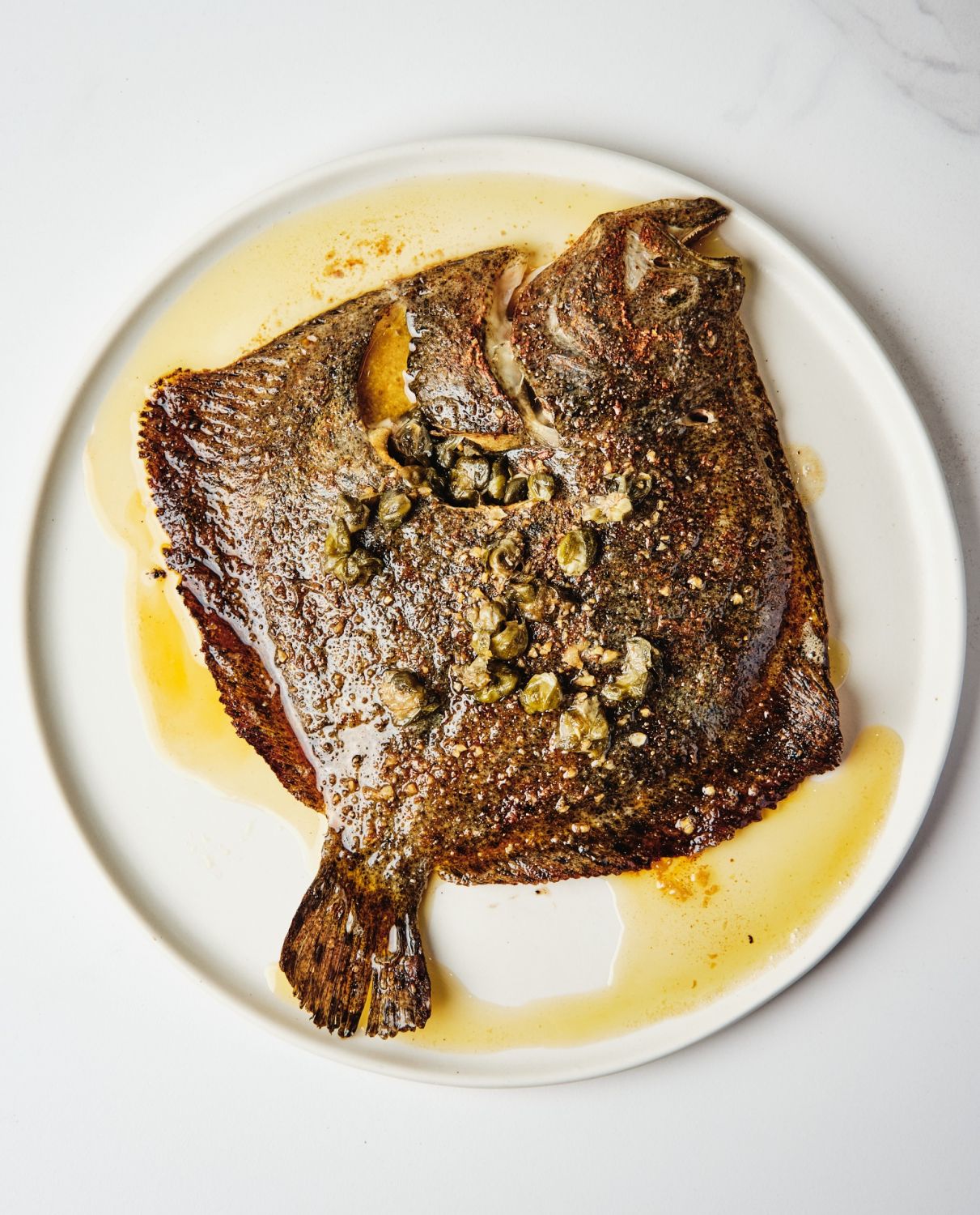 Turbot cooked with brown butter and capers at Ember by Josh Boutwood