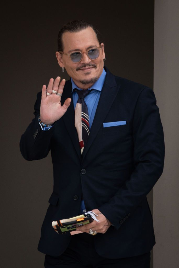 FAIRFAX, VA - MAY 5: (NY & NJ NEWSPAPERS OUT) Johnny Depp waves to his fans during the afternoon recess outside court during the Johnny Depp and Amber Heard civil trial at Fairfax County Circuit Court on May 5, 2022 in Fairfax, Virginia. Depp is seeking $50 million in alleged damages to his career over an op-ed Heard wrote in the Washington Post in 2018.(Photo by Cliff Owen/Consolidated News Pictures/Getty Images)