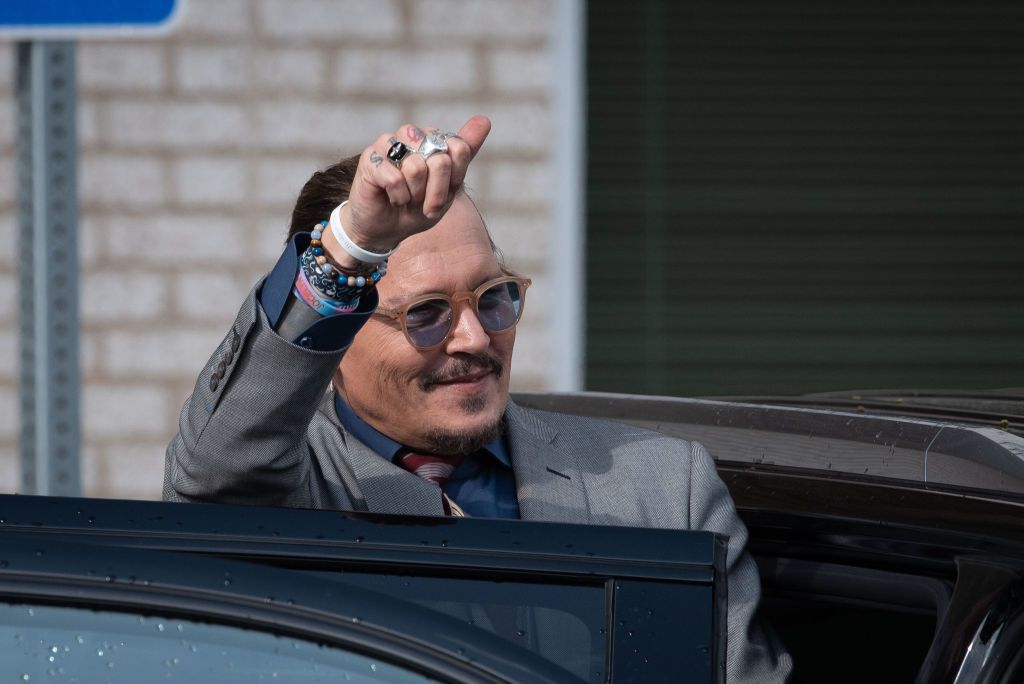 FAIRFAX, VA - May 16: (NY & NJ NEWSPAPERS OUT) Johnny Depp waves to supporters as he departs outside court during the Johnny Depp and Amber Heard civil trial at Fairfax County Circuit Court on May 16, 2022 in Fairfax, Virginia. Depp is seeking $50 million in alleged damages to his career over an op-ed Heard wrote in the Washington Post in 2018.(Photo by Cliff Owen/Consolidated News Pictures/Getty Images)