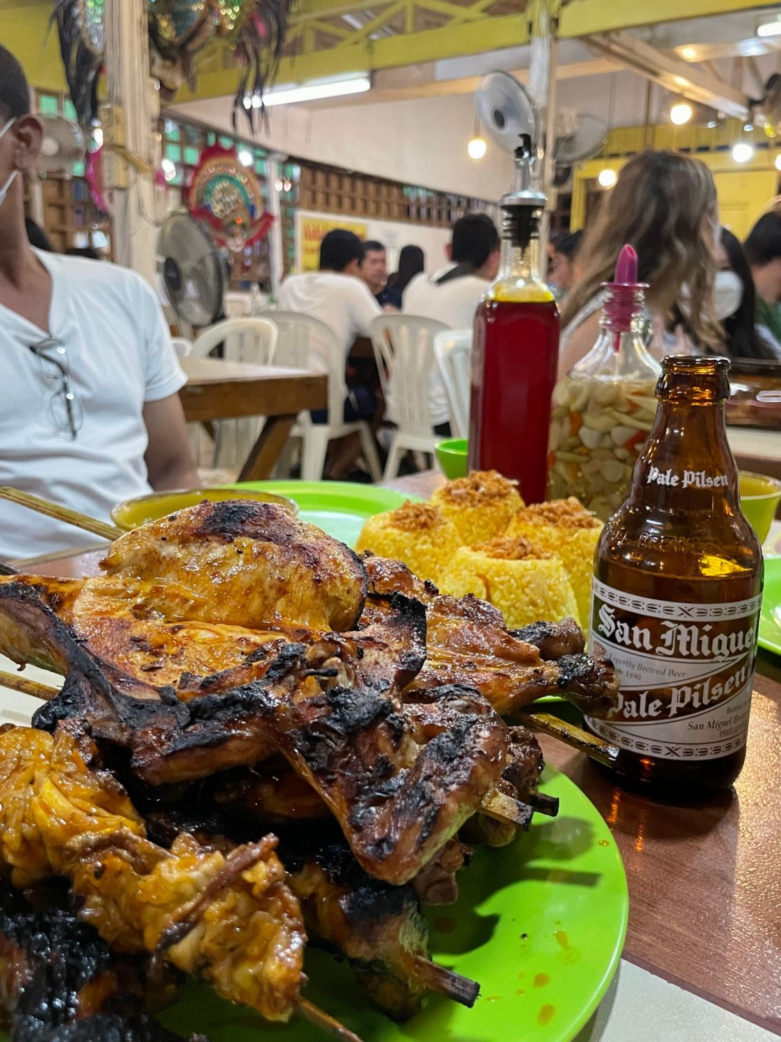 A pile of inasal from Aida’s Chicken calls from a cold San Miguel beer
