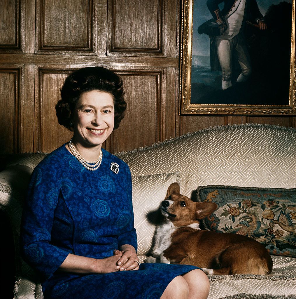 Queen Elizabeth II with one of her corgis at Sandringham, 1970. (Photo by Fox Photos/Hulton Archive/Getty Images)