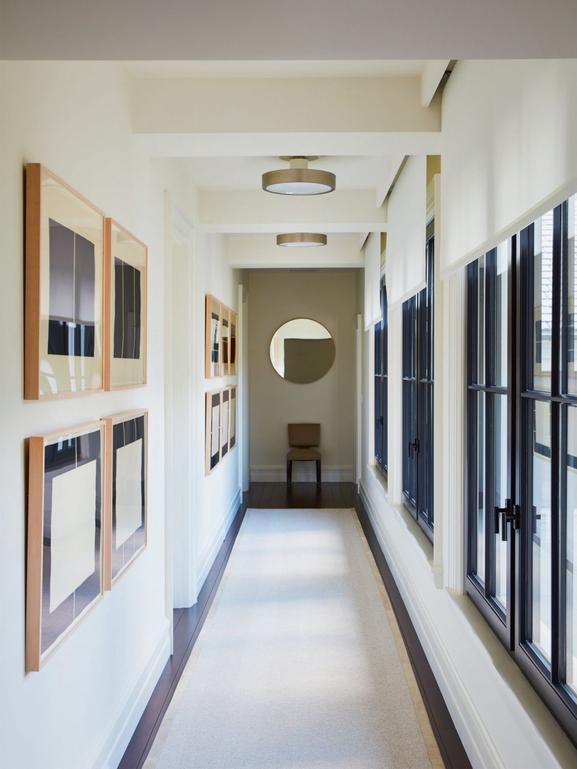 This hallway doubles as a gallery space for the homeowners to showcase more artworks