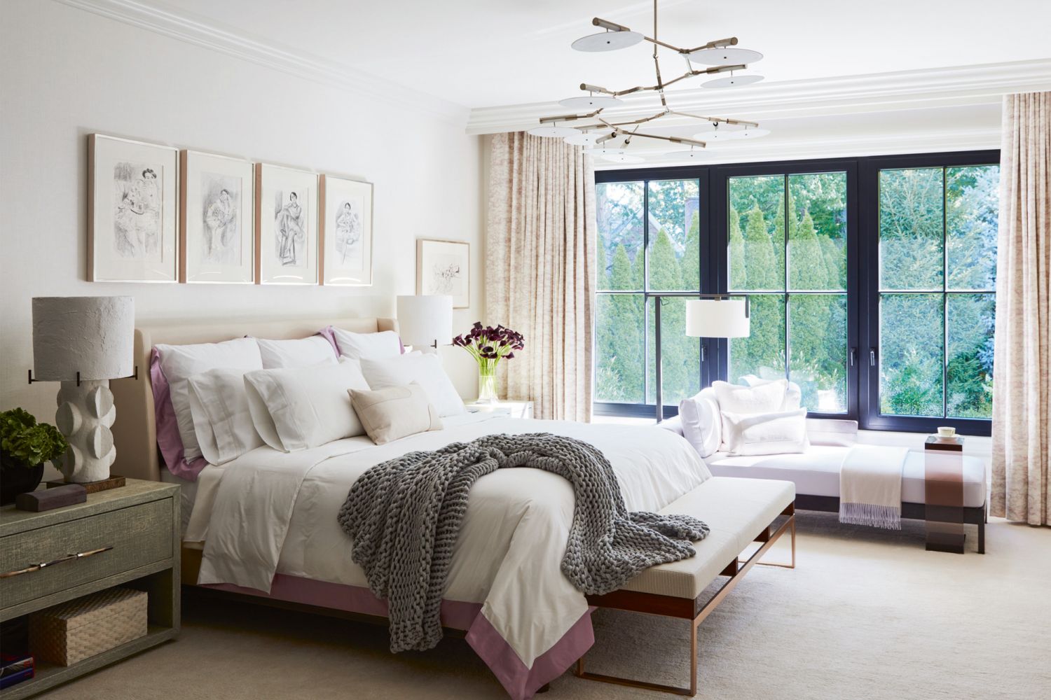 The master bedroom is furnished with a daybed from Liaigre and lamps by American lighting designer Lindsey Adelman, alongside an area rug from Holland & Sherry