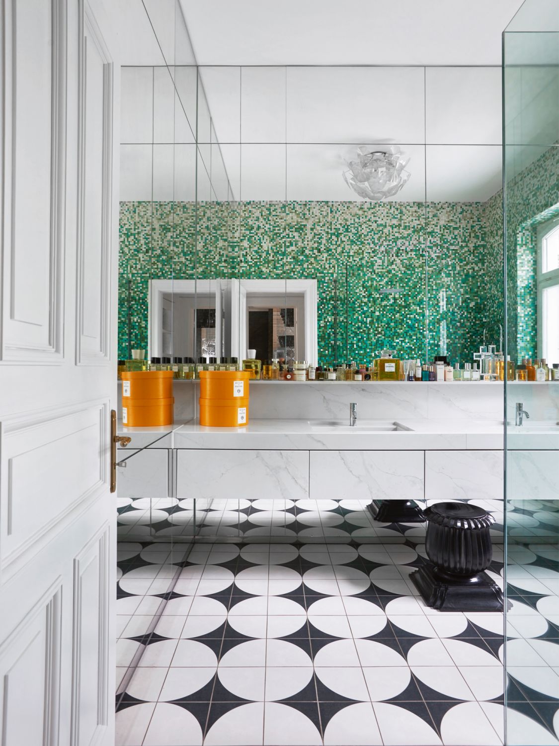 The bathroom features mosaic wall and floor tiles from Bisazza