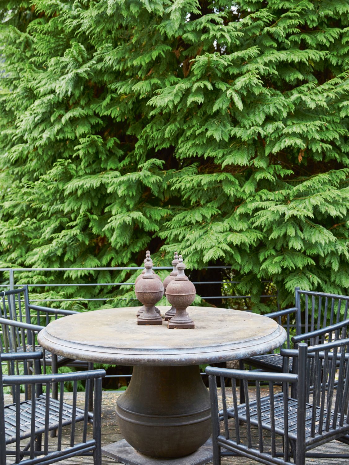 The decorative items on the outdoor table are among the pieces bought at local antique markets and during Schandorff’s travels