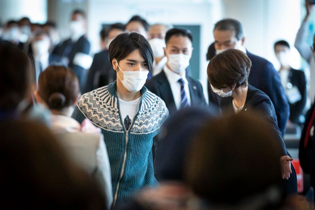 TOKYO, JAPAN - NOVEMBER 14: Kei Komuro walks past the boarding gate amongst other passengers upon departure at Haneda Airport on November 14, 2021 in Tokyo, Japan. (Photo by Yuichi Yamazaki/Getty Images)