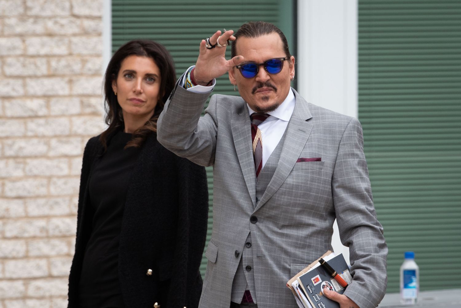 FAIRFAX, VA - MAY 26: (NY & NJ NEWSPAPERS OUT) Johnny Depp waves to his fans as he walks outside court during the Johnny Depp and Amber Heard civil trial at Fairfax County Circuit Court on May 26, 2022 in Fairfax, Virginia. Depp is seeking $50 million in alleged damages to his career over an op-ed Heard wrote in the Washington Post in 2018.(Photo by Cliff Owen/Consolidated News Pictures/Getty Images)