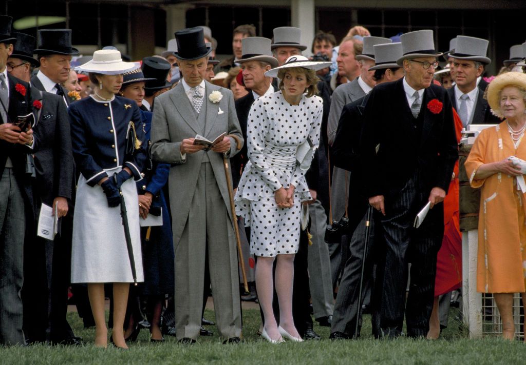 View of various members of the British royal family and others as they watch the Royal Ascot derby, Ascot, England, June 4, 1986. Among those pictured are Anne, Princess Royal (left, in white skirt), Diana, Princess of Wales (1961 - 1997) (center, in polka dots), and Queen Elizabeth the Queen Mother (1900 - 2002) (right, in peach). (Photo by Derek Hudson/Getty Images)