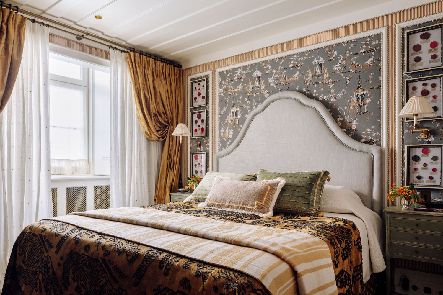 This bedroom is the picture of refined elegance with its plush bedding and playful wall covering