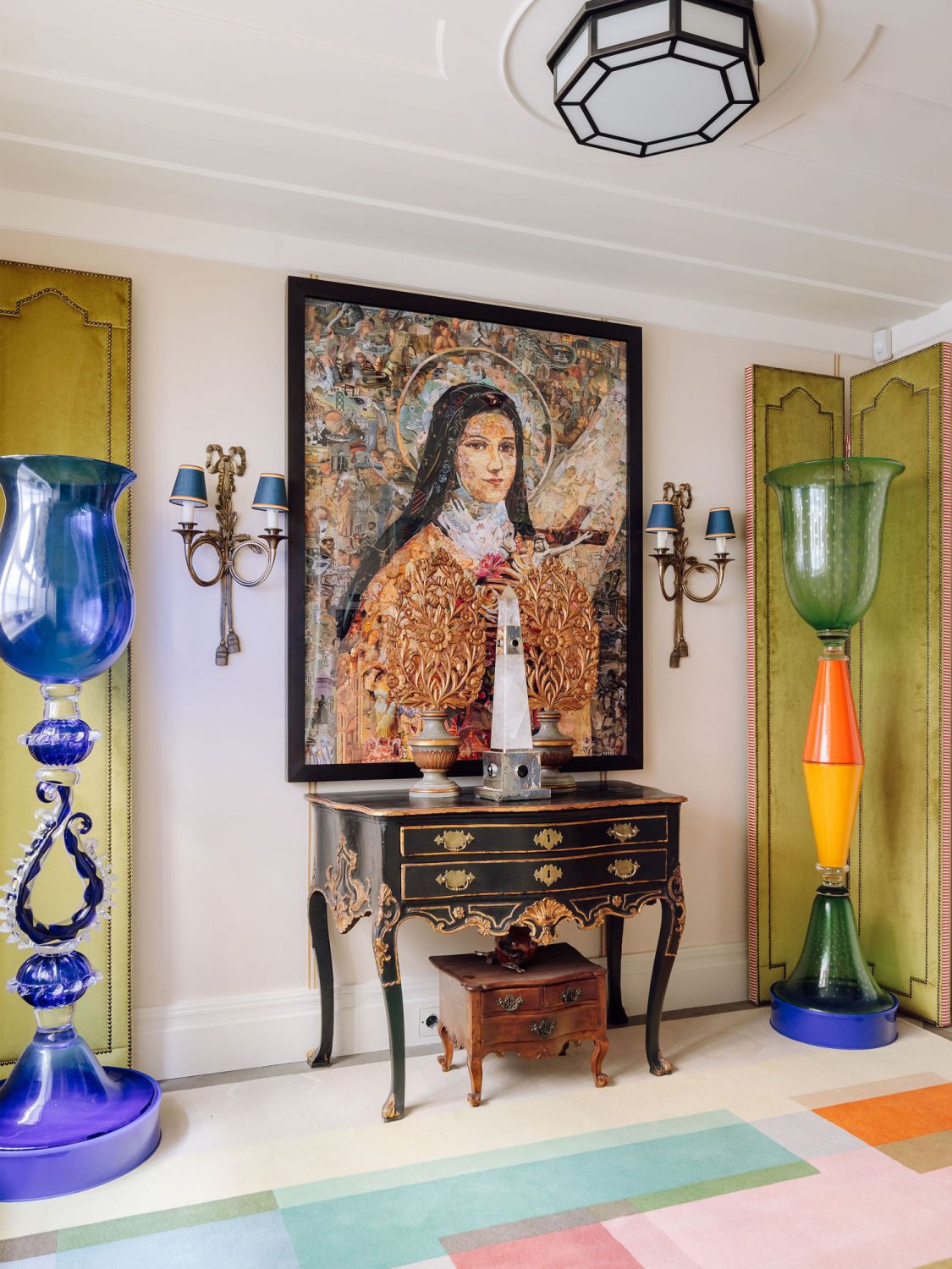An antique dresser sits under the Imaginaria: Saint Therese of Lisieux artwork by Brazilian artist Vik Muniz