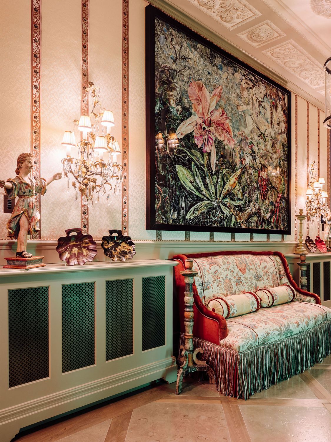 The florals in the large painting is echoed in the prints of the loveseat