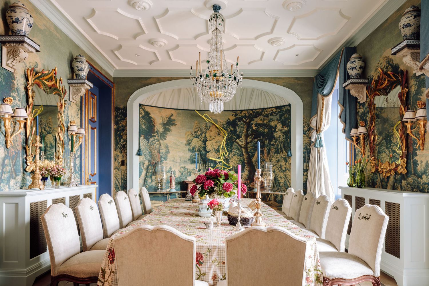 Dining chairs etched with motivating words add a bespoke touch to the extravagant dining room