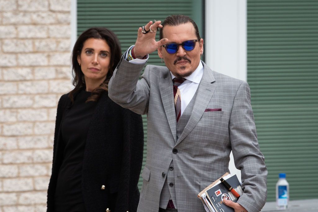 FAIRFAX, VA - MAY 26: (NY & NJ NEWSPAPERS OUT) Johnny Depp waves to his fans as he walks outside court during the Johnny Depp and Amber Heard civil trial at Fairfax County Circuit Court on May 26, 2022 in Fairfax, Virginia. Depp is seeking $50 million in alleged damages to his career over an op-ed Heard wrote in the Washington Post in 2018.(Photo by Cliff Owen/Consolidated News Pictures/Getty Images)