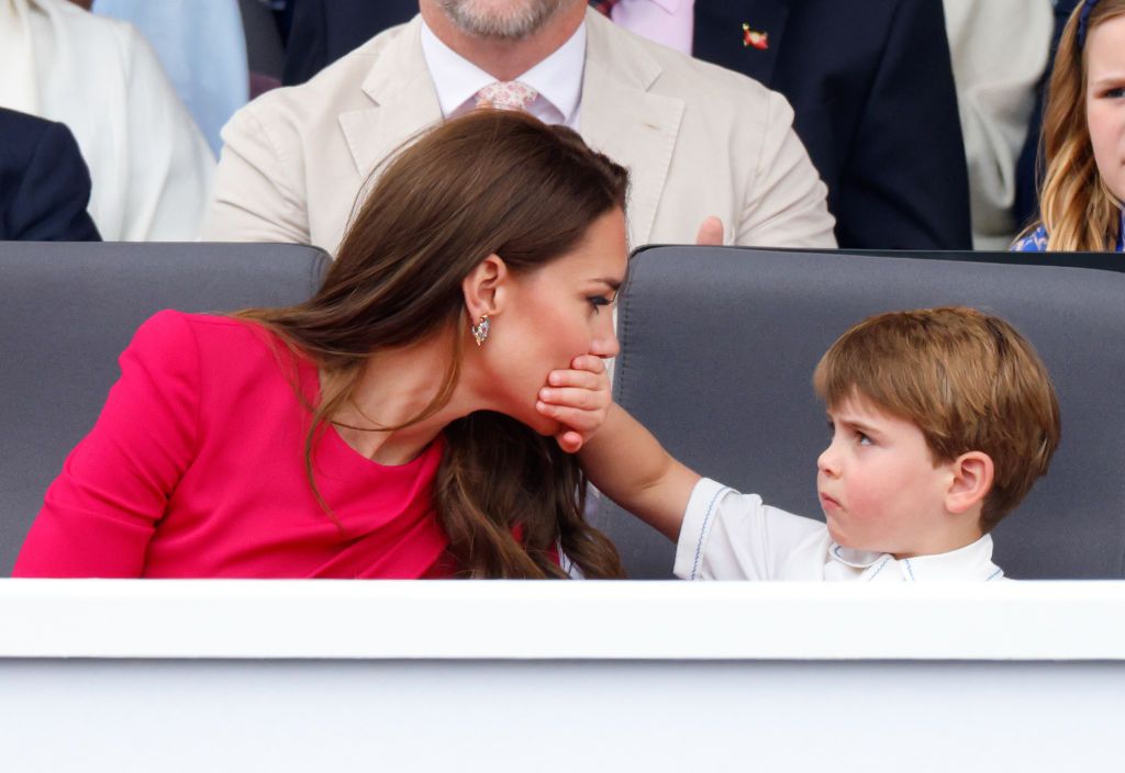LONDON, UNITED KINGDOM - JUNE 05: (EMBARGOED FOR PUBLICATION IN UK NEWSPAPERS UNTIL 24 HOURS AFTER CREATE DATE AND TIME) Prince Louis of Cambridge covers his mother Catherine, Duchess of Cambridge's mouth with his hand as they attend the Platinum Pageant on The Mall on June 5, 2022 in London, England. The Platinum Jubilee of Elizabeth II is being celebrated from June 2 to June 5, 2022, in the UK and Commonwealth to mark the 70th anniversary of the accession of Queen Elizabeth II on 6 February 1952. (Photo b