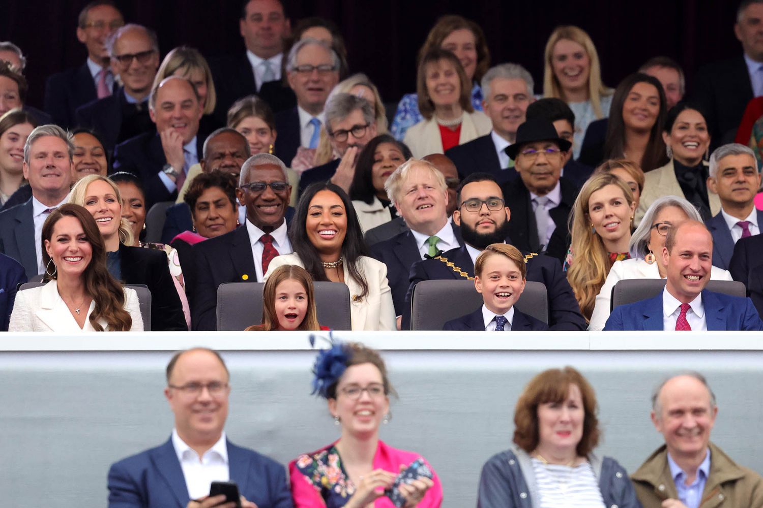Catherine, Princess Charlotte, Prince George and Prince William watch Paddington Bear and The Queen on screen during the Platinum Party at the Palace in front of Buckingham Palace. (Photo: Getty Images)