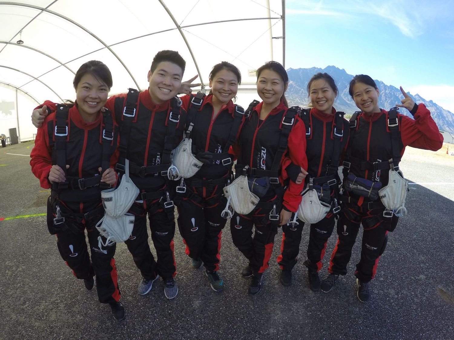 Li Hua Tan skydiving with her siblings in New Zealand