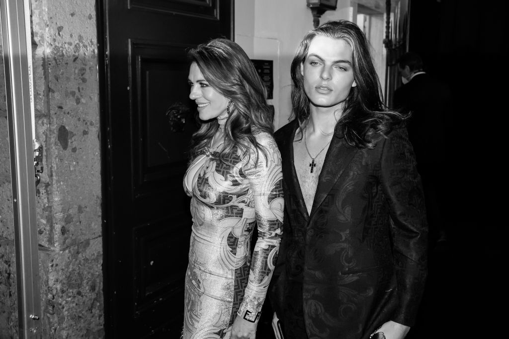 MILAN, ITALY - SEPTEMBER 26: (EDITOR'S NOTE: This image has been converted to black and white) British actress Elizabeth Hurley with her son Damian Charles Hurley seen at the party organized for the launch of the Fendace collection, a joint collection between Fendi and Versace, on September 26, 2021 in Milan, Italy. (Photo