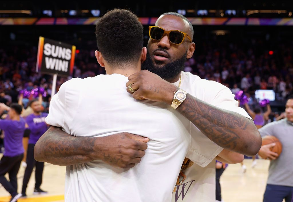PHOENIX, ARIZONA - APRIL 05: LeBron James #6 of the Los Angeles Lakers hugs Devin Booker #1 of the Phoenix Suns following the NBA game at Footprint Center on April 05, 2022 in Phoenix, Arizona. The Suns defeated the Lakers 121-110. NOTE TO USER: User expressly acknowledges and agrees that, by downloading and or using this photograph, User is consenting to the terms and conditions of the Getty Images License Agreement. (Photo by Christian Petersen/Getty Images)