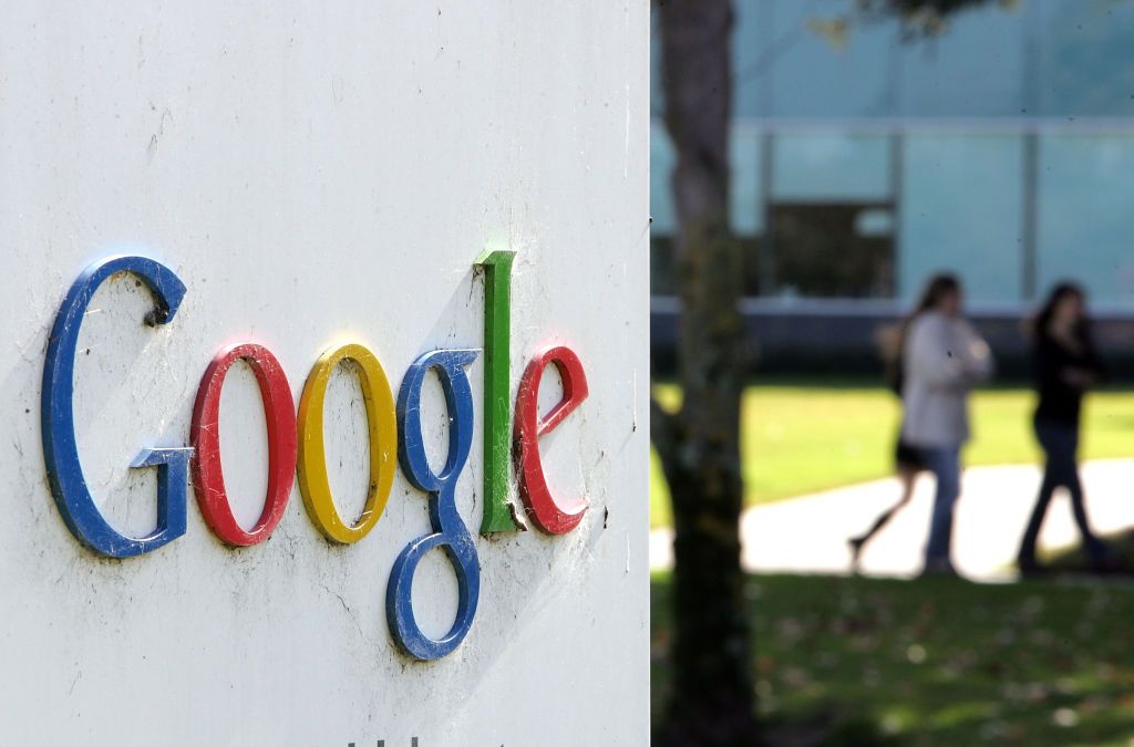 MOUNTAIN VIEW, CA - JANUARY 31: People walk near a sign outside of Google headquarters January 31, 2007 in Mountain View, California. Google Inc. reported its fourth quarter earnings today with net income growing to $1.03 billion or $3.29 per share compared to $372.2 million or $1.22 a share one year ago. Gross revenues were up 67 percent to $3.21 billion. (Photo by Justin Sullivan/Getty Images)