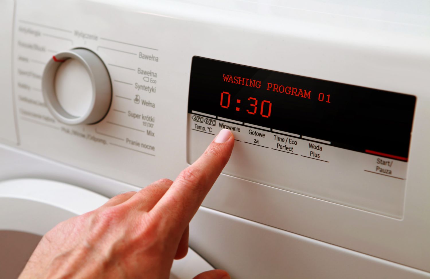 Close up of man hand adjusting washing machine