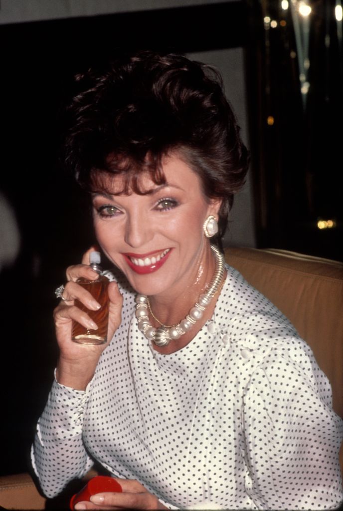 NEW YORK - CIRCA 1983: Joan Collins Promotes Revlon's 'Scoundrel' Perfume circa 1983 in New York City. (Photo by Robin Platzer/Getty Images)