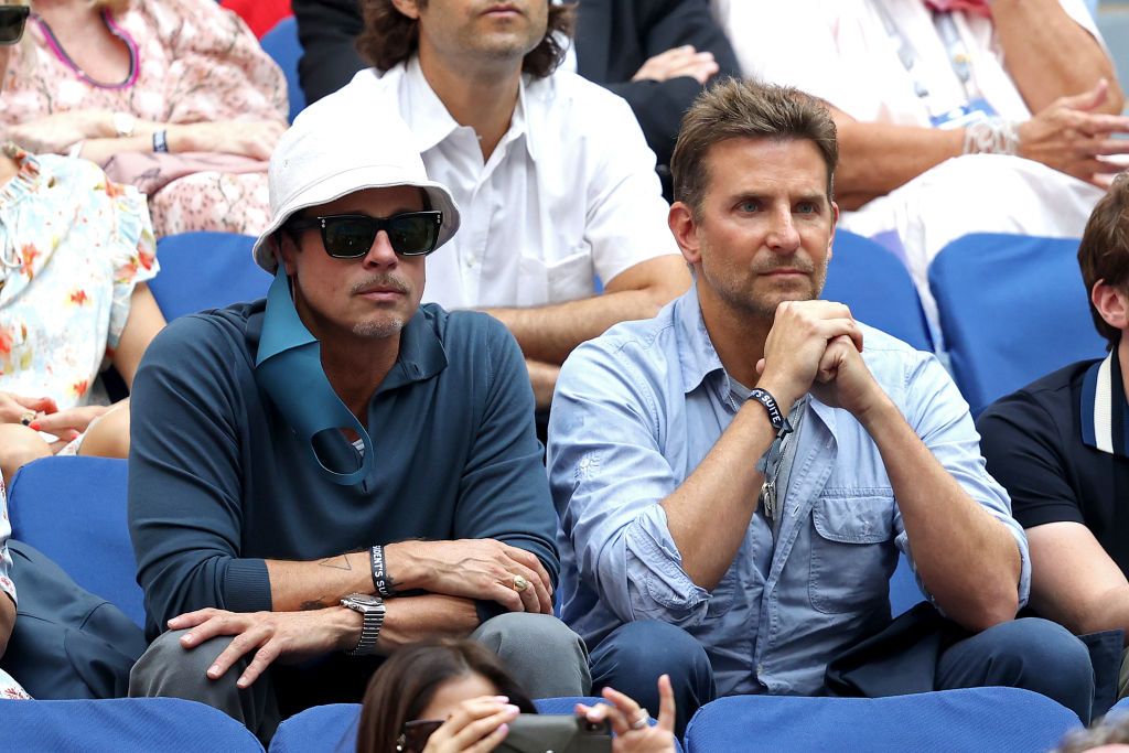 NEW YORK, NEW YORK - SEPTEMBER 12: (L-R) Actors Brad Pitt and Bradley Cooper watch the Men's Singles final match between Daniil Medvedev of Russia and Novak Djokovic of Serbia on Day Fourteen of the 2021 US Open at the USTA Billie Jean King National Tennis Center on September 12, 2021 in the Flushing neighborhood of the Queens borough of New York City. (Photo by Matthew Stockman/Getty Images)
