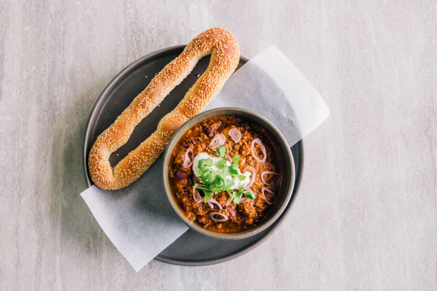 A Jerusalem bagel with chilli corn carne, yoghurt and grilled lemon from Tucker