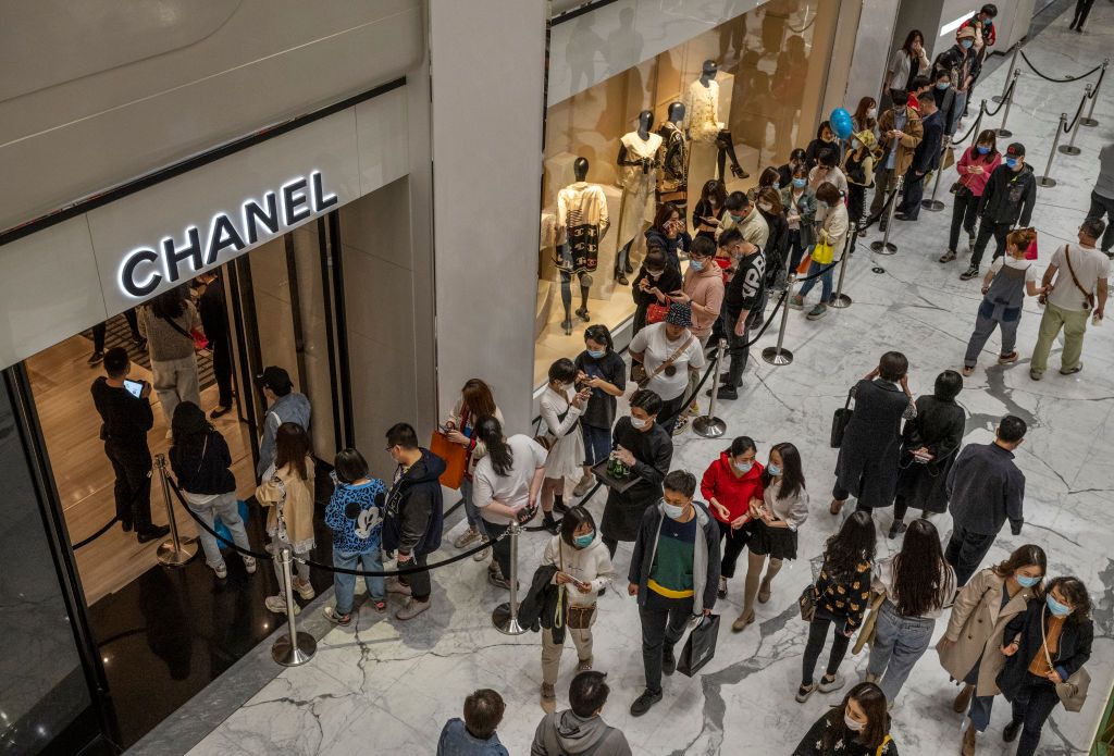 BEIJING, CHINA - April 18: Shoppers wait in line outside a Chanel store at a mall on April 18, 2021 in Beijing, China. China announced robust economic growth of 18.3 percent in the first quarter of 2021, compared to the same period last year when the world's second largest economy ground to a halt due to the COVID-19 pandemic. (Photo by Kevin Frayer/Getty Images)