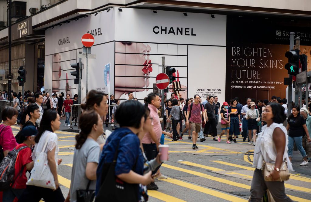 HONG KONG - 2019/04/26: Pedestrians are seen crossing the street past French multinational Chanel cosmetic beauty brand advertisement in Causeway Bay, Hong Kong. (Photo by Budrul Chukrut/SOPA Images/LightRocket via Getty Images)
