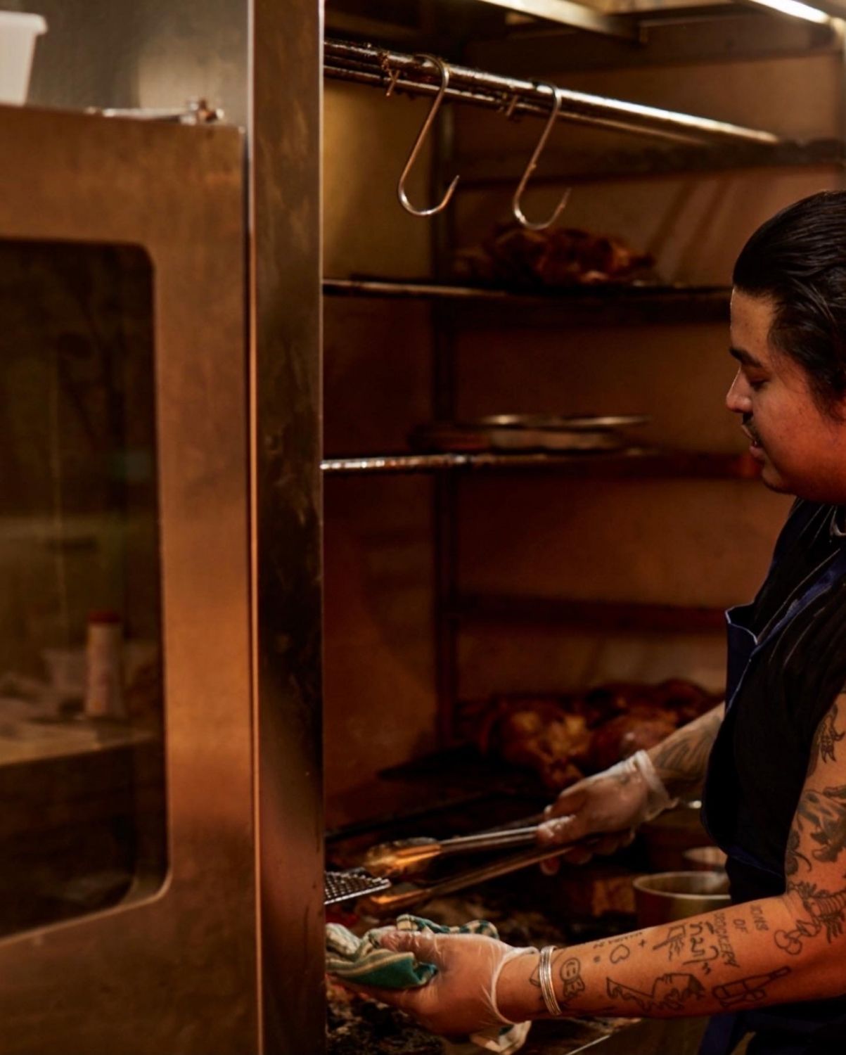 Chef Ross Magnaye working the woodfire grill at Serai (Photo: Jana Langhorst)