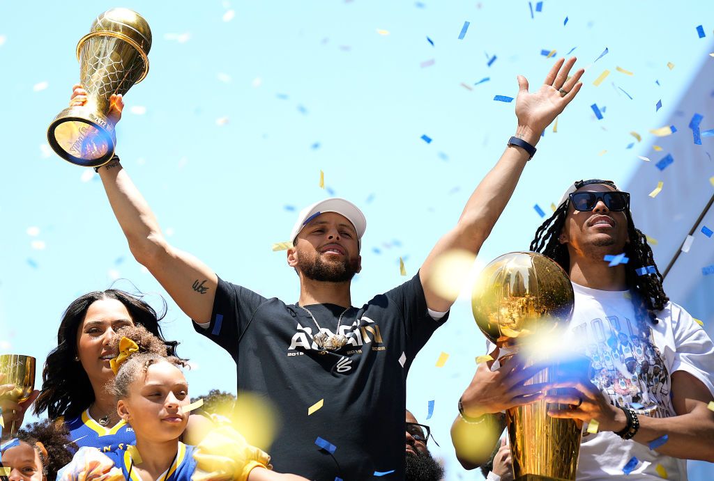 SAN FRANCISCO, CALIFORNIA - JUNE 20: Stephen Curry #30 and Damion Lee #1 of the Golden State Warriors celebrate with the NBA Championship Trophy and Curry's NBA Finals Most Valuable Player Award during the Golden State Warriors Victory Parade on June 20, 2022 in San Francisco, California. The Golden State Warriors beat the Boston Celtics 4-2 to win the 2022 NBA Finals. NOTE TO USER: User expressly acknowledges and agrees that, by downloading and or using this photograph, User is consenting to the terms and
