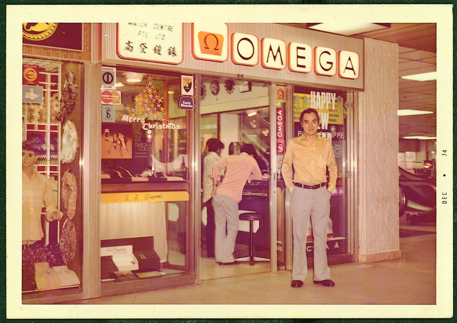 Anthony Lim posing in front of his first watch boutique in Colombo Court in Singapore in 1972