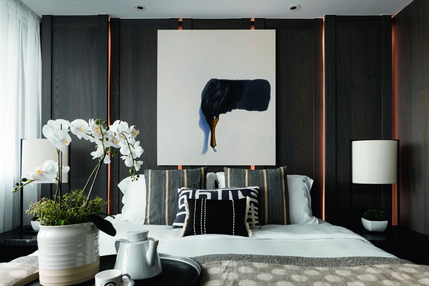Concealed lighting strips incorporated into the feature wall give the master bedroom a soft glow at night