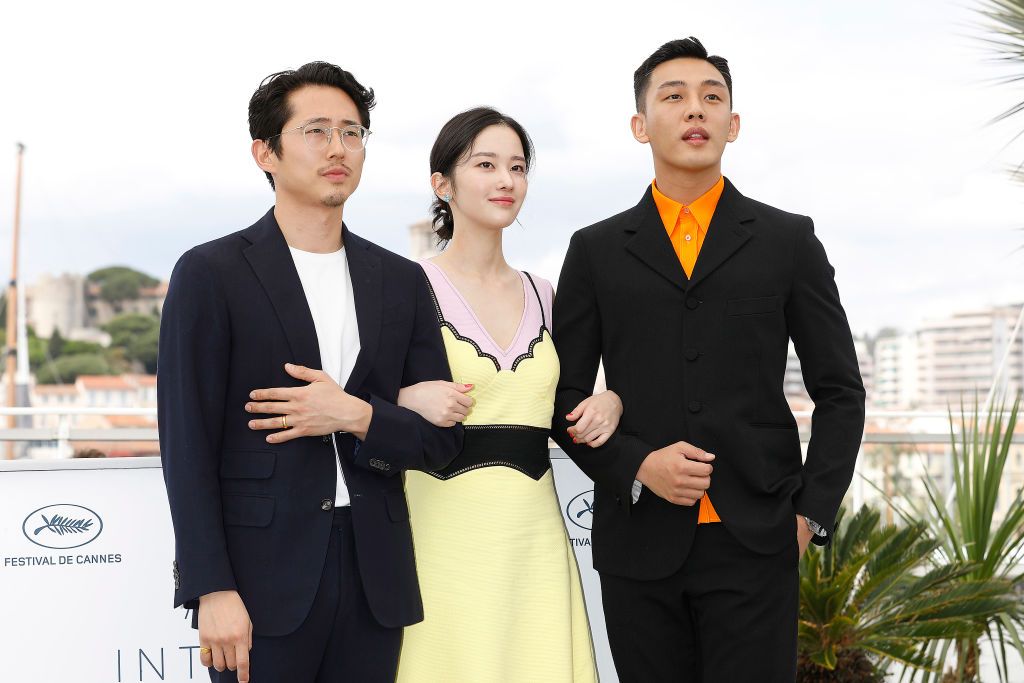 (R-L:) Director Chang-dong Lee, Ah-in Yoo, Steven Yeun and actress Jong-seo Jeon at the "Burning" photocall during the 71st Cannes Film Festival at the Palais des Festivals on May ZZZ, 2018 in Cannes, France. (Photo credit should read John Rasimus/Future Publishing via Getty Images)