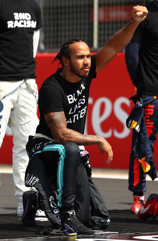 NORTHAMPTON, ENGLAND - AUGUST 09: Lewis Hamilton of Great Britain and Mercedes GP takes a knee on the grid in support of the Black Lives Matter movement prior to the F1 70th Anniversary Grand Prix at Silverstone on August 09, 2020 in Northampton, England. (Photo by Bryn Lennon/Getty Images)