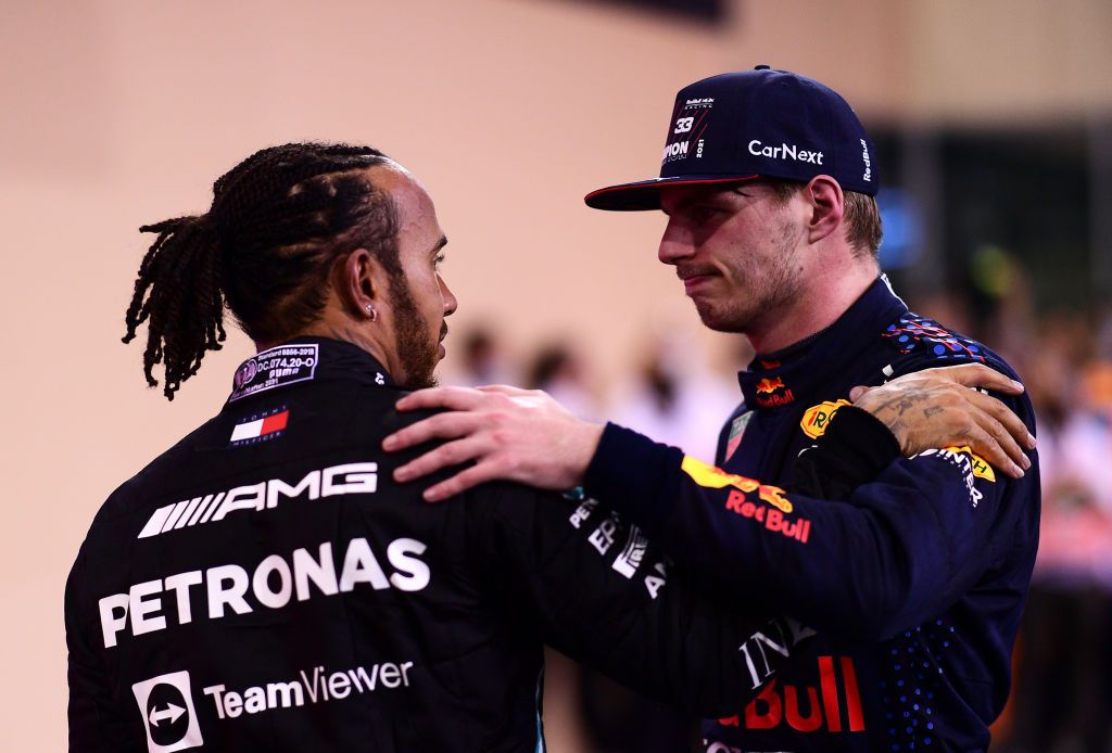 ABU DHABI, UNITED ARAB EMIRATES - DECEMBER 12: Race winner and 2021 F1 World Drivers Champion Max Verstappen of Netherlands and Red Bull Racing is congratulated by runner up in the race and championship Lewis Hamilton of Great Britain and Mercedes GP during the F1 Grand Prix of Abu Dhabi at Yas Marina Circuit on December 12, 2021 in Abu Dhabi, United Arab Emirates. (Photo by Mario Renzi - Formula 1/Formula 1 via Getty Images)