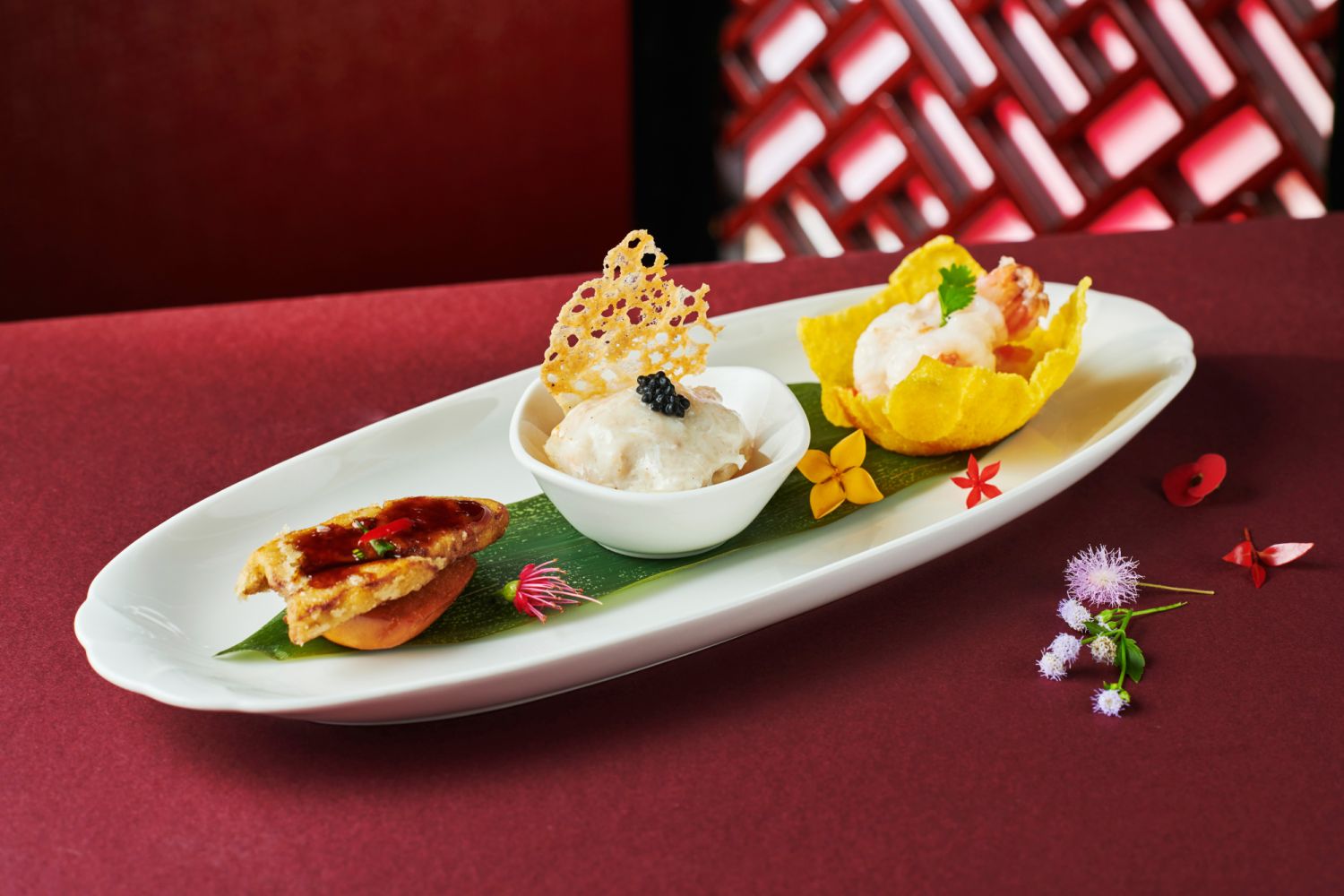 Shang Palace's Classic Trio Combination with lobster and seafood with truffle, stuffed prawn paste with fish maw and crabmeat sauce, and foie gras with honey sauce served with a fried mantou (Photo: Shangri-La Kuala Lumpur)