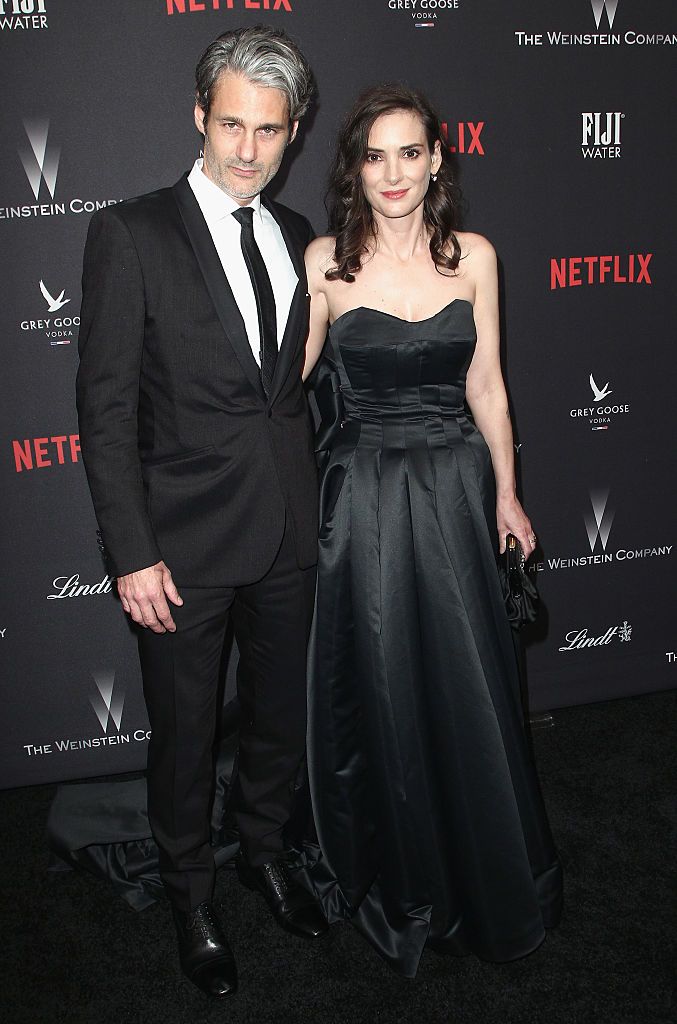 BEVERLY HILLS, CA - JANUARY 08:  Scott Mackinlay Hahn (L) and actress Winona Ryder attend The Weinstein Company and Netflix Golden Globe Party, presented with FIJI Water, Grey Goose Vodka, Lindt Chocolate, and Moroccanoil at The Beverly Hilton Hotel on January 8, 2017 in Beverly Hills, California.  (Photo by Tommaso Boddi/Getty Images for The Weinstein Company)