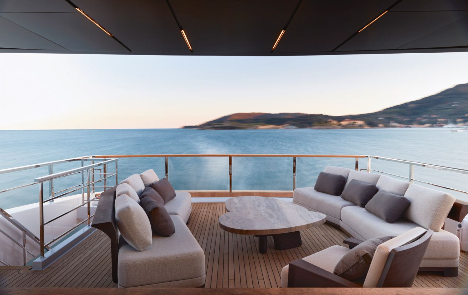 The deck features custom outdoor furnishings by Liaigre that play with the contrast of curved forms and angular shapes also found in the interior of the vessel