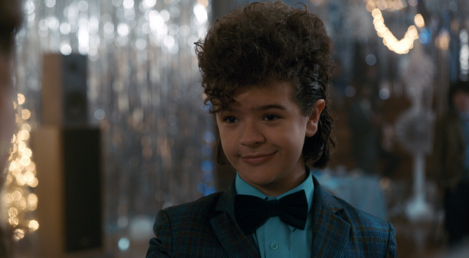 It isn't the 80s without high, voluminous hairstyles. But Dustin really outdone himself by sporting a big hairdo, courtesy of Steve, and a full plaid suit