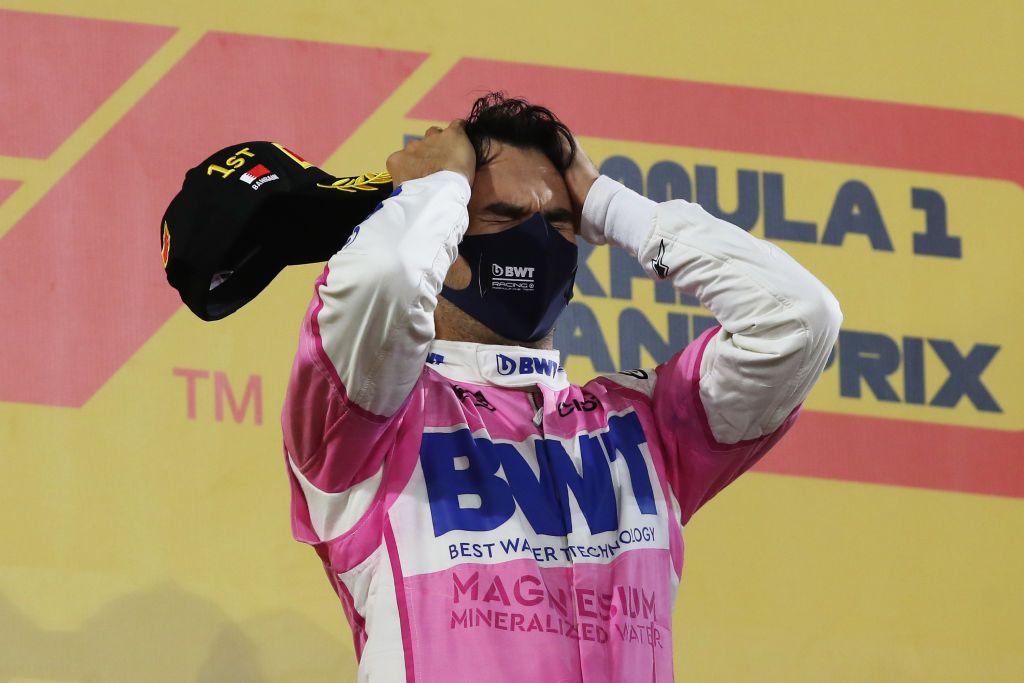 BAHRAIN, BAHRAIN - DECEMBER 06: Race winner Sergio Perez of Mexico and Racing Point celebrates on the podium during the F1 Grand Prix of Sakhir at Bahrain International Circuit on December 06, 2020 in Bahrain, Bahrain. (Photo by Tolga Bozoglu - Pool/Getty Images)