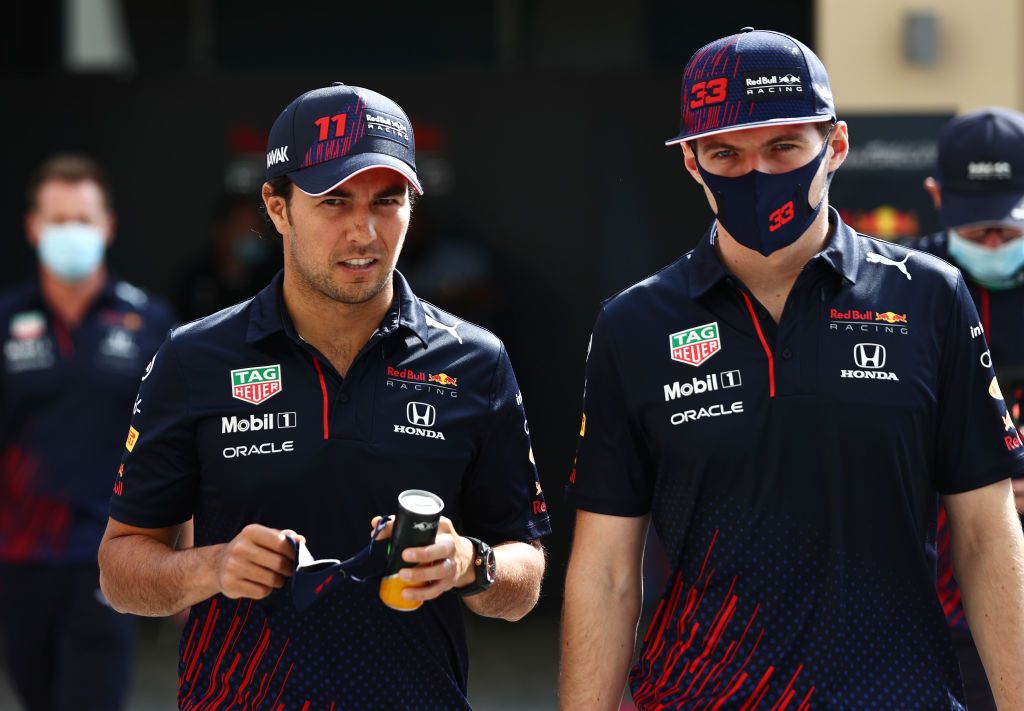 ABU DHABI, UNITED ARAB EMIRATES - DECEMBER 12: Sergio Perez of Mexico and Red Bull Racing and Max Verstappen of Netherlands and Red Bull Racing walks in the Paddock before the F1 Grand Prix of Abu Dhabi at Yas Marina Circuit on December 12, 2021 in Abu Dhabi, United Arab Emirates. (Photo by Mark Thompson/Getty Images)