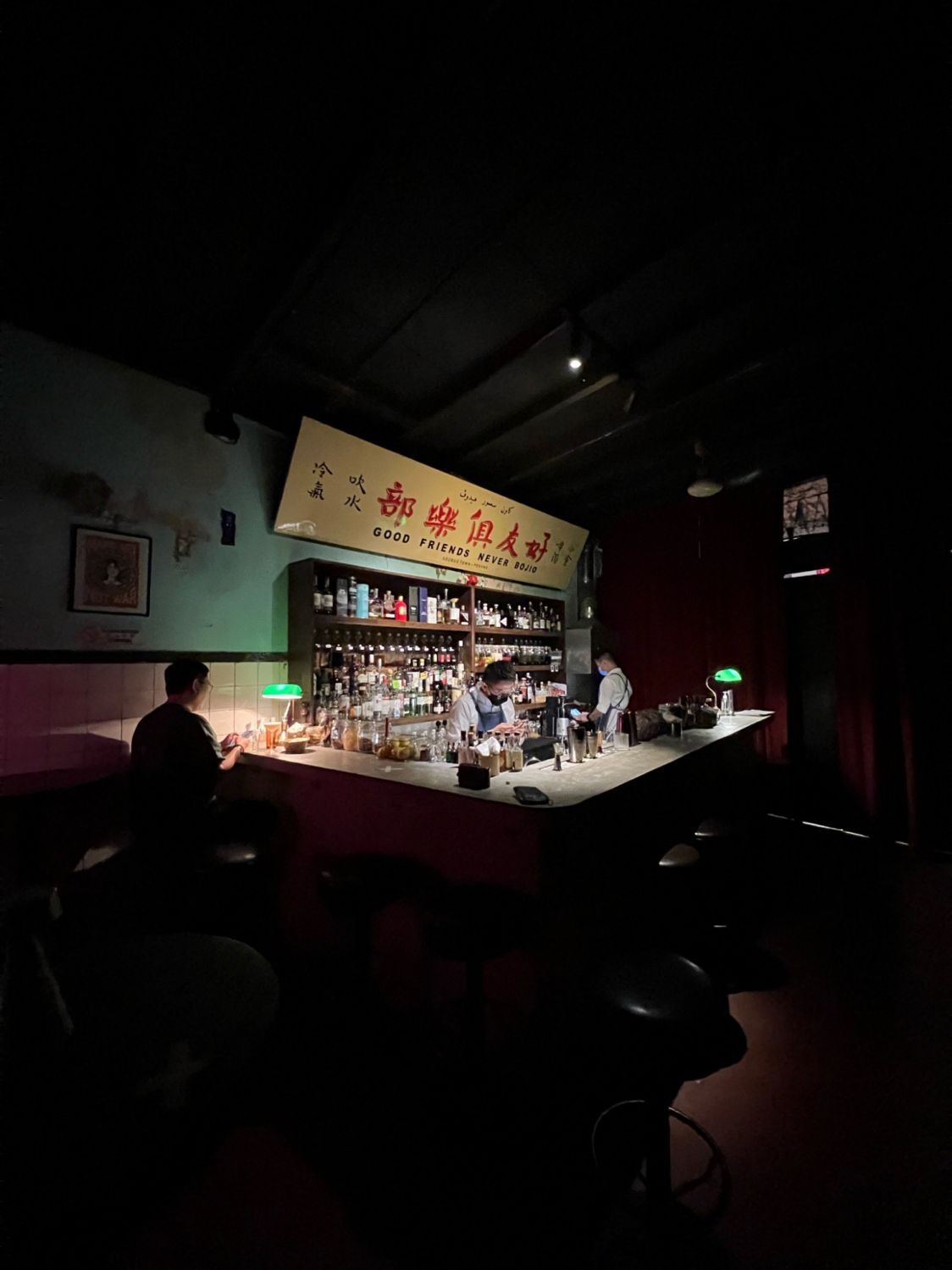 The bar area at Good Friends Club, adorned with a sign printed with the bar's motto (Photo: Good Friends Club)