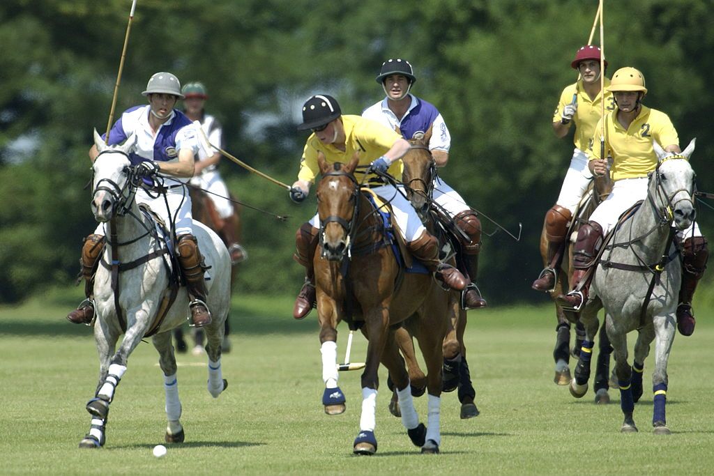 CIRENCESTER, UNITED KINGDOM - JUNE 24: Prince Harry In Polo Match With Team Members Satnam Dhillon (no2 In Yellow Shirt) And Eduardo Novillo-astrada (no3 In Yellow Shirt) (check Identities) Competing For The Mountbatten Trophy Sponsored By Credit Suisse. The Match In Aid Of The Mountbatten Memorial Fund And Cirencester Park Polo Club Is Being Played At The Club (Photo by Tim Graham Photo Library via Getty Images)