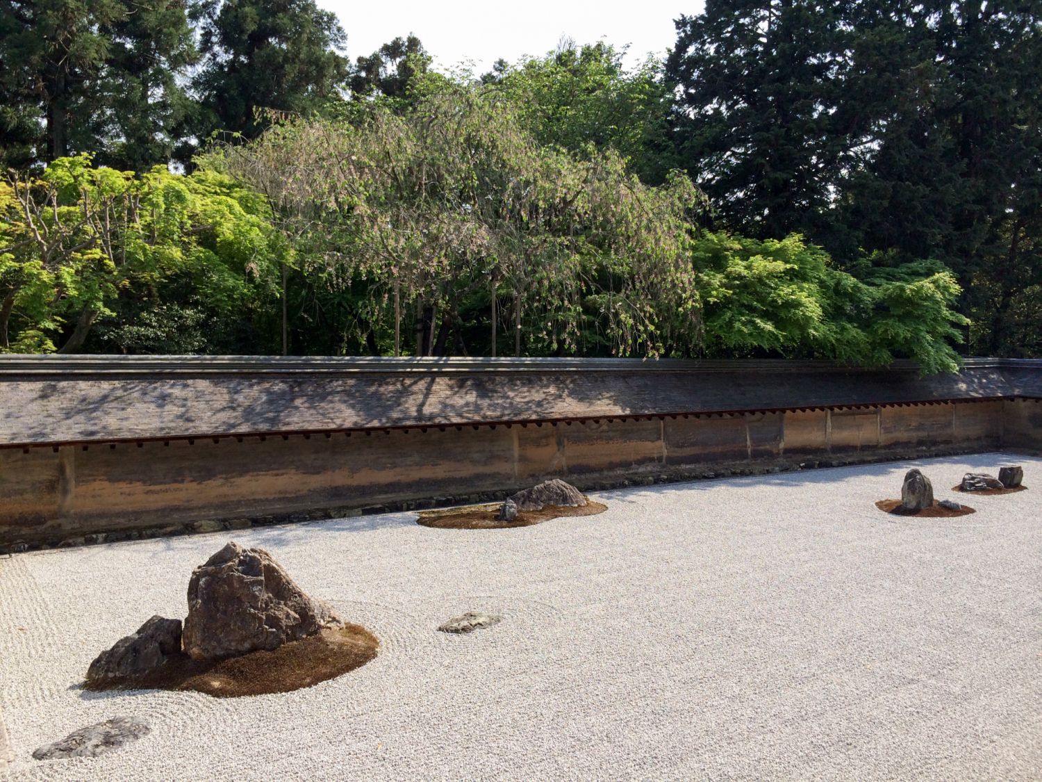 The most famous dry landscape garden in Japan at Ryoan-ji Temple in the city of Kyoto