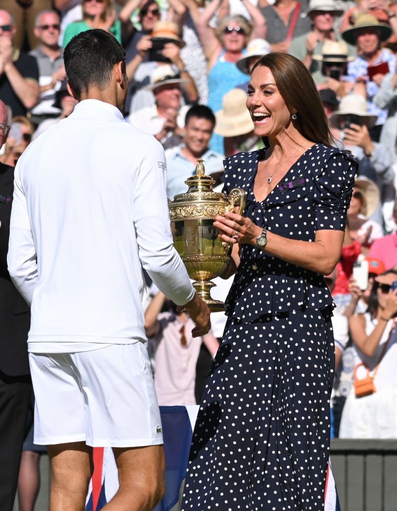 LONDON, ENGLAND - JULY 10: Catherine, Duchess of Cambridge presents Novak Djokovic with the Wimbledon Trophy after winning the Wimbledon Men's Singles Final at All England Lawn Tennis and Croquet Club on July 10, 2022 in London, England. (Photo by Karwai Tang/WireImage)