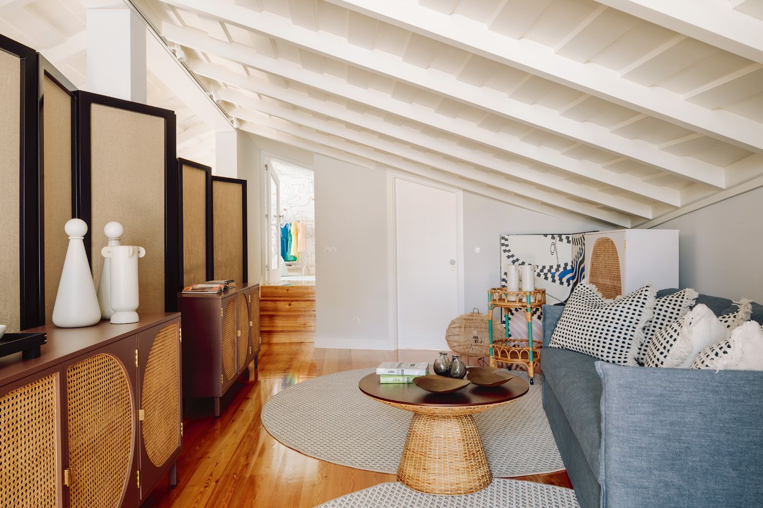 Rounded forms and circular motifs add to the cosy feel of this attic space