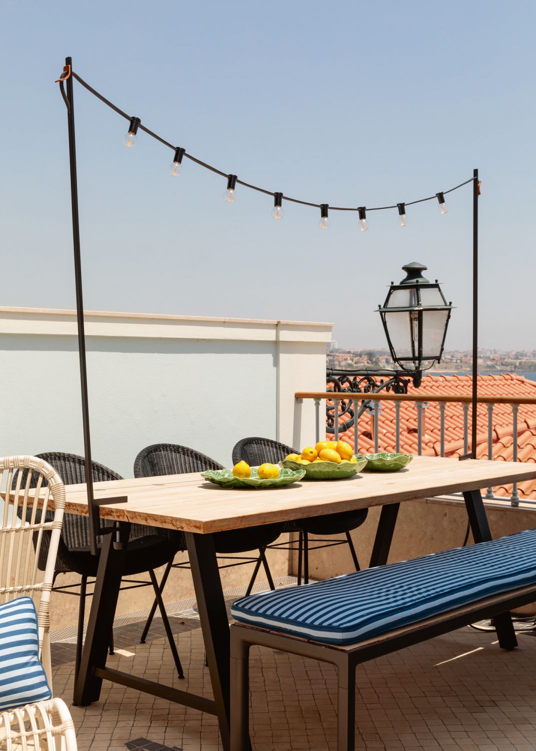 Furnished with striped upholstery and woven seats, the rooftop terrace is the perfect spot for family meals